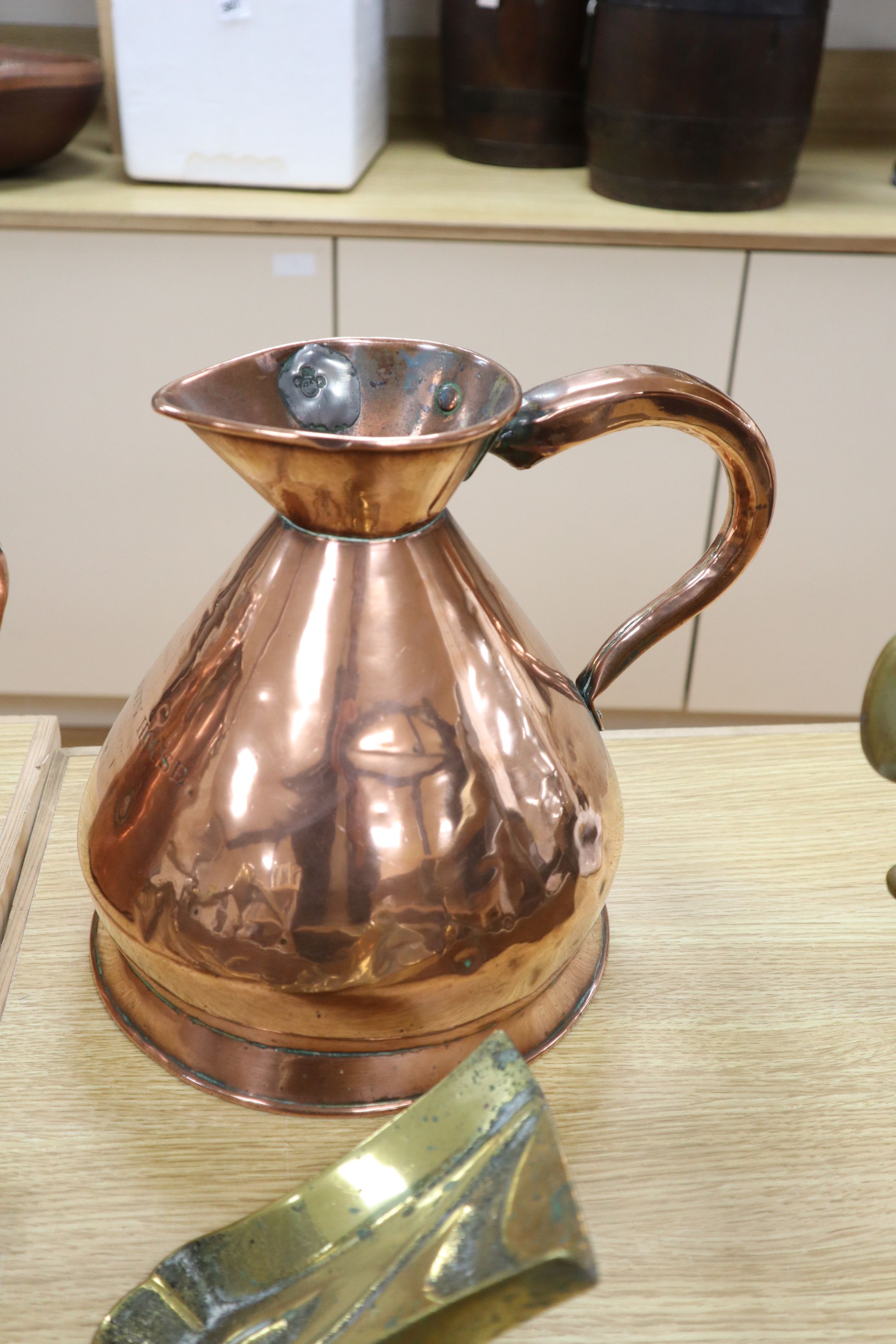 A late Victorian Art Nouveau brass fire kerb, length 132cm, a set of three Victorian fire brasses, a Dutch copper water can and a coppe